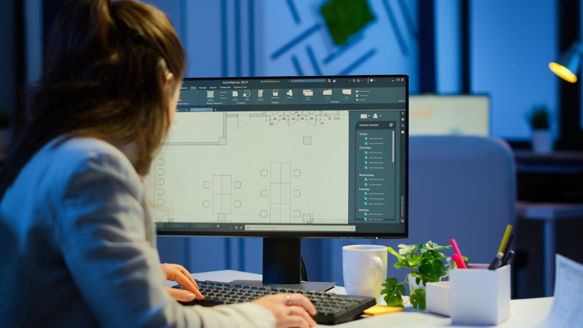 shoulder-shot-engineer-working-with-architectural-plans-cad-software-desktop-computer-designer-using-arhitecture-blueprints-buildings-working-overtime-creating-studying-1920x1080